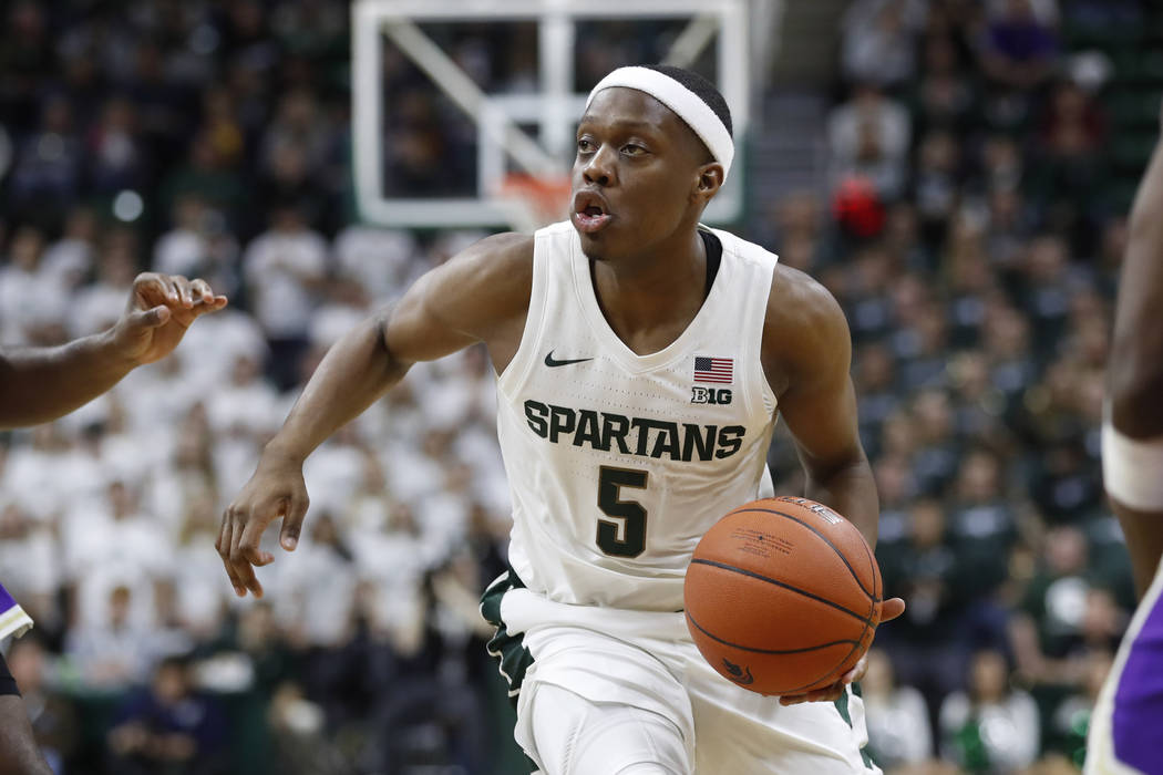 Michigan State guard Cassius Winston brings the ball up court during the second half of an NCAA ...