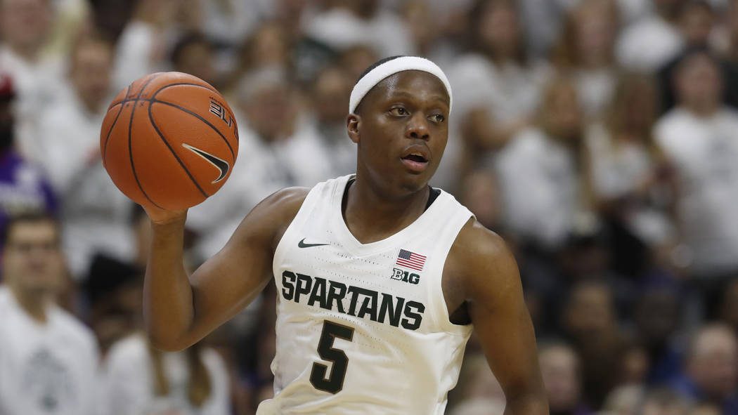 Michigan State guard Cassius Winston brings the ball up court during the second half of an NCAA ...
