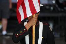 A member of the Basic High School JROTC color guard presents the colors during a One Hero at a ...