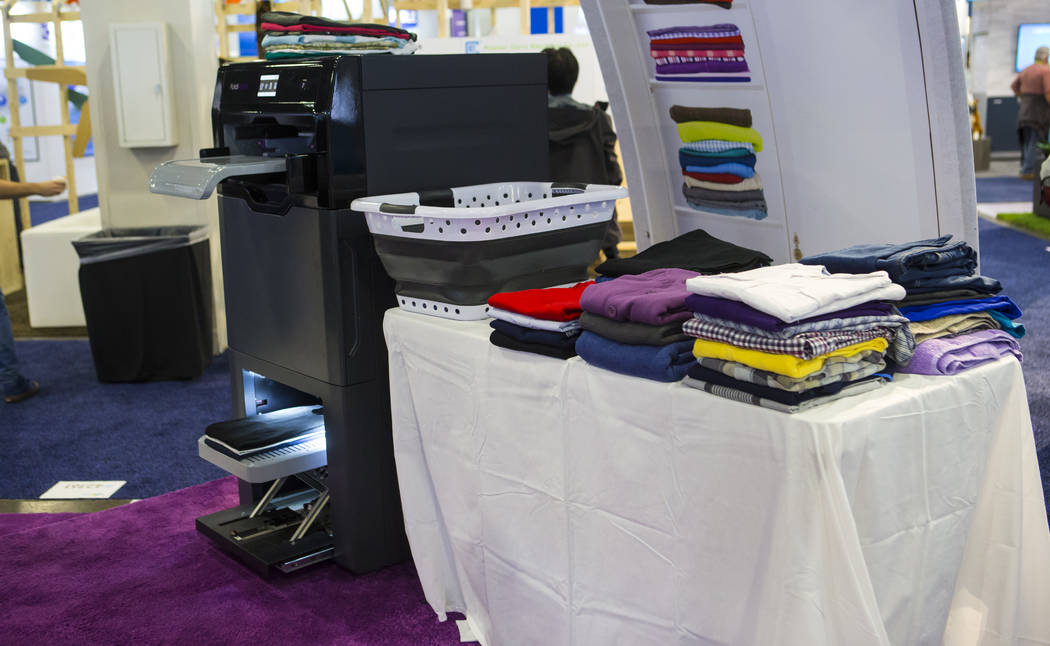 Laundry-folding robot Foldimate, left, on display at the Sands Expo and  Convention Center durin …