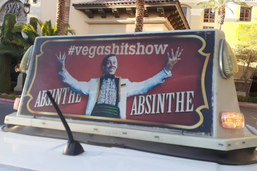 An advertisement for the show "Absinthe" seen atop a taxi Friday, Oct. 24, 2019, at G ...