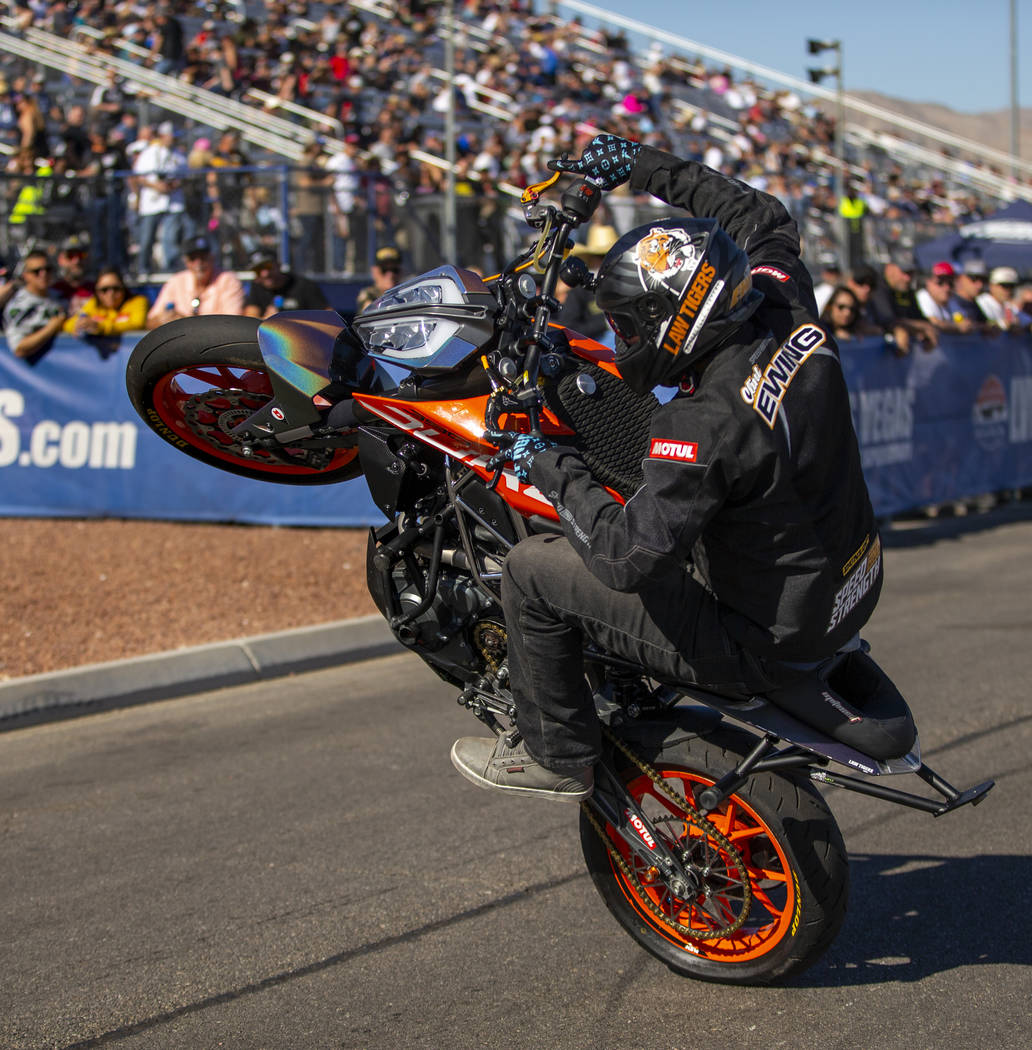 Stunt rider Clint Ewing entertain the fans before the start of the second round of the Dodge NH ...