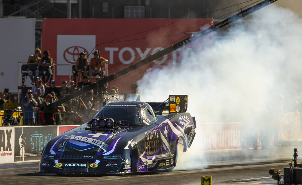 Funny Car racer Jack Beckman burns his tires during the second round of the Dodge NHRA National ...