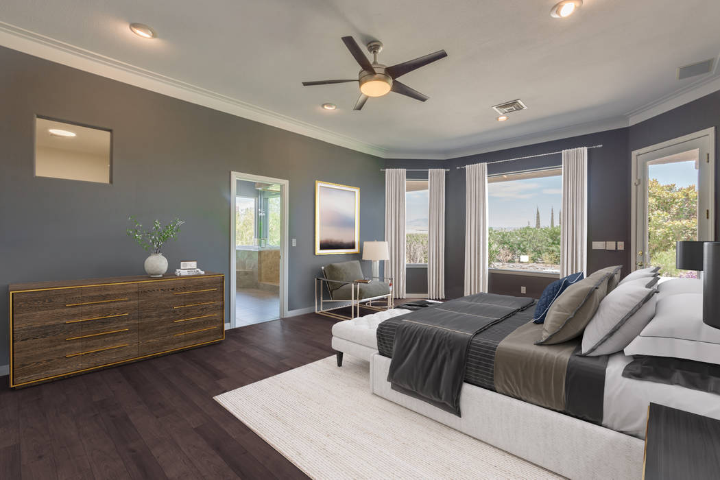 The private master bedroom retreat has hardwood flooring, crown molding and access to an outsid ...
