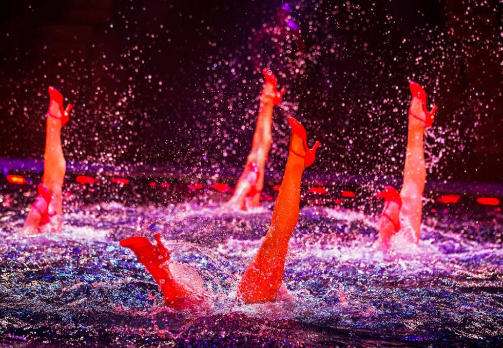 Synchronized swimmers practice during rehearsal for "Le Rêve- The Dream." After each show, the ...