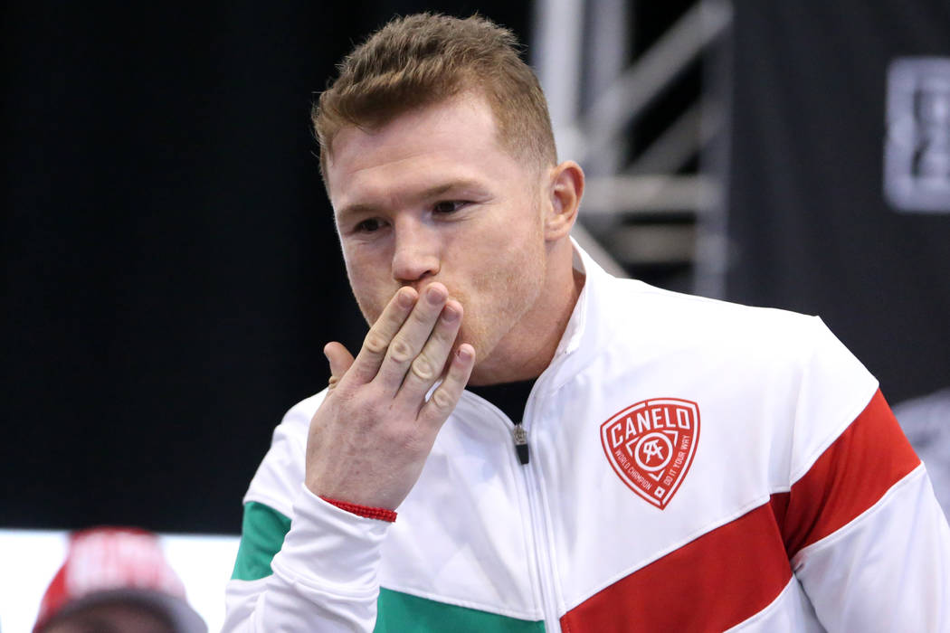 Canelo Alvarez motions to his family during a weigh-in event at the MGM Grand Garden Arena in L ...