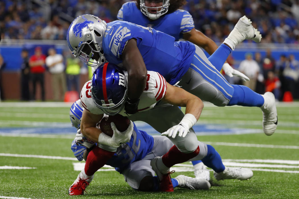 Detroit Lions middle linebacker Jarrad Davis (40) tackles New York Giants tight end Rhett Ellis ...