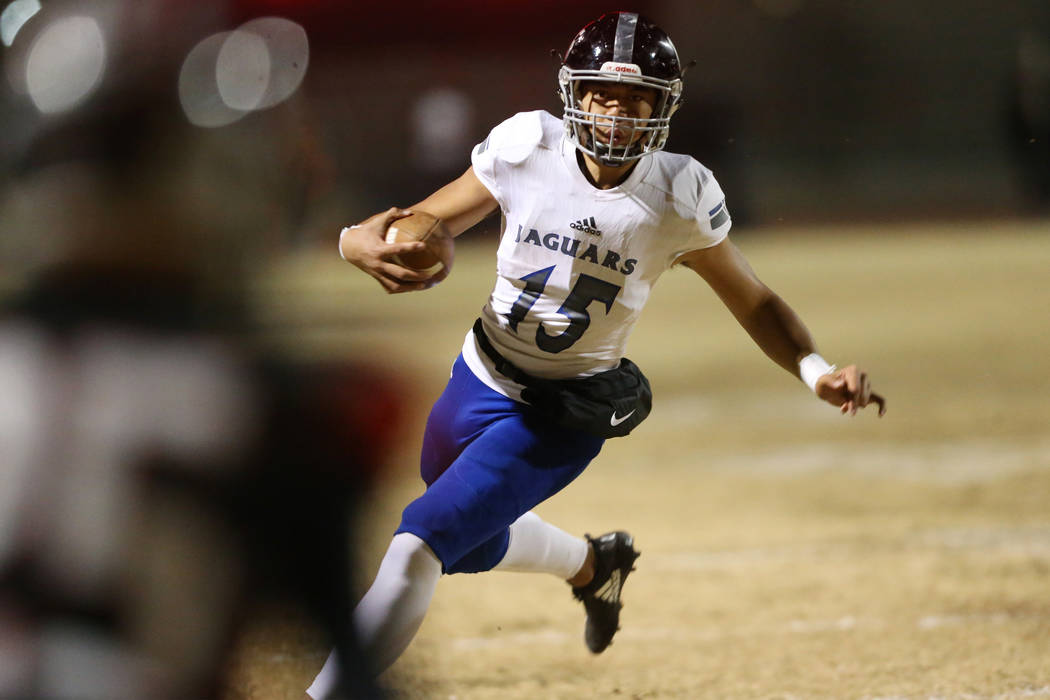 Desert Pines Rjay Tagataese (15) runs the ball against Las Vegas during the second quarter of a ...