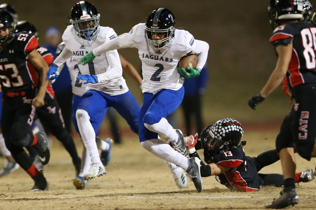 Desert Pines Deandre Moore (2) is tackled by Las Vegas Dalton Silet (13) while retuning a kicko ...