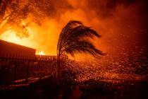 Strong, dry winds send embers flying as the Hillside Fire burns in San Bernardino, Calif., on T ...