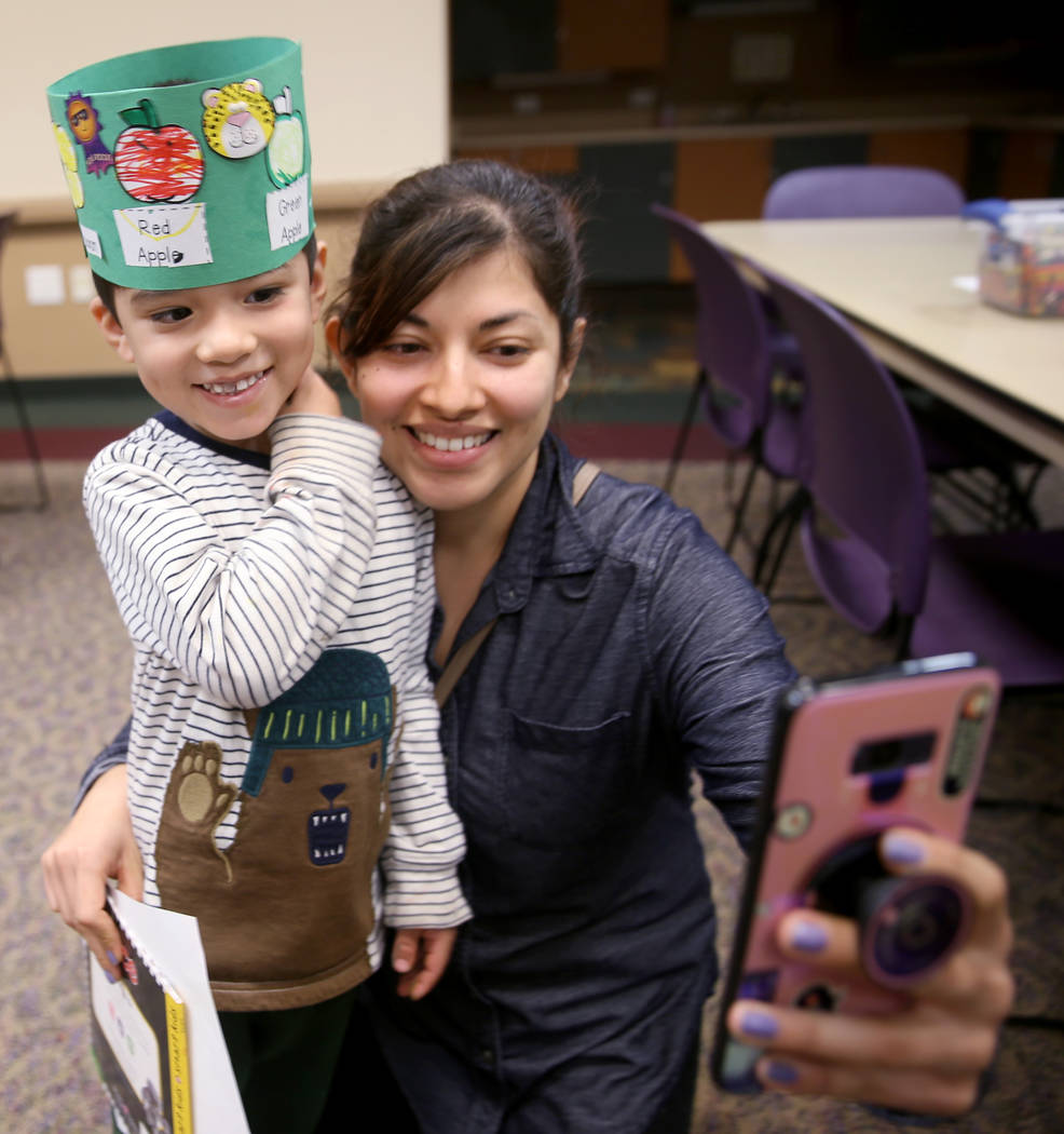 Christian Falcon, 3, dons his "life cycle hat" with his mom Berenice Falcon during a ...