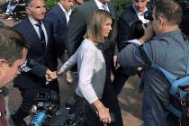 In an Aug. 27, 2019, file photograph, actress Lori Loughlin departs hand in hand with her husba ...