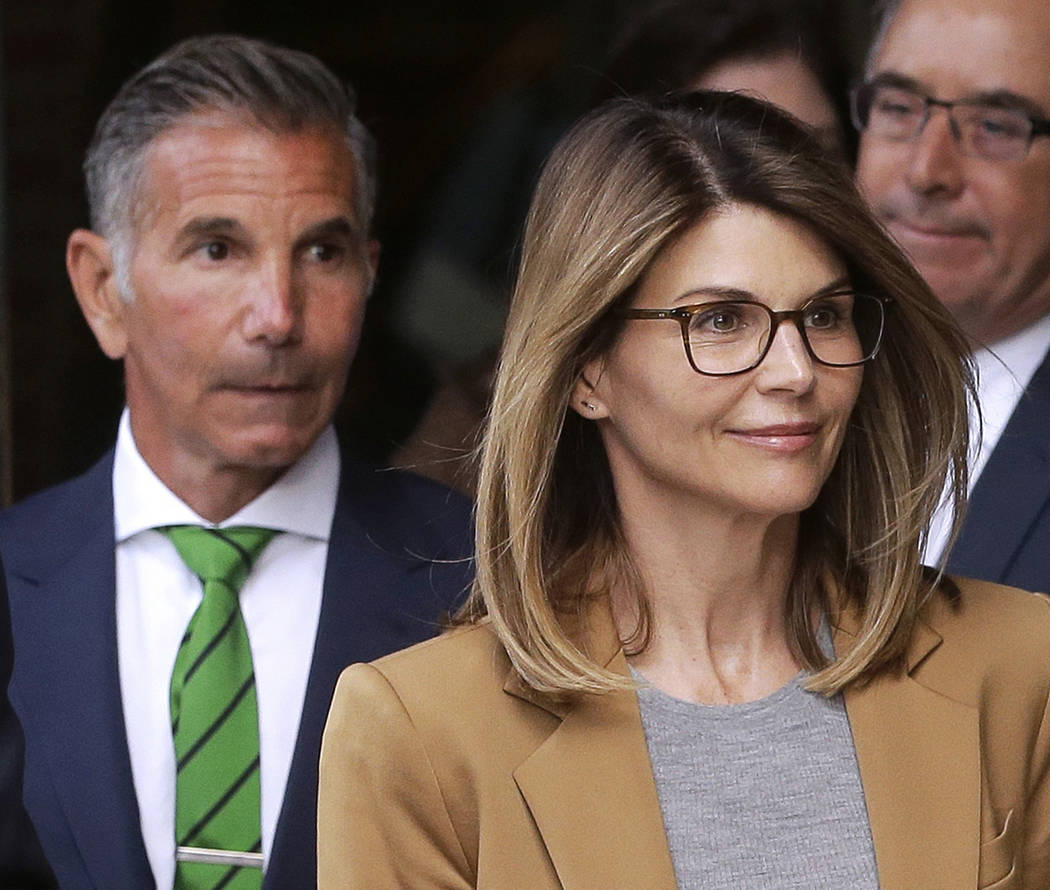 FILE - In this April 3, 2019, file photo, actress Lori Loughlin, front, and husband, clothing d ...