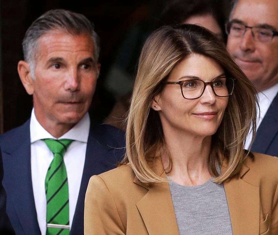 FILE - In this April 3, 2019, file photo, actress Lori Loughlin, front, and husband, clothing d ...