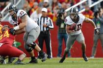 Oklahoma State running back Chuba Hubbard, right, runs the ball during the first half of an NCA ...