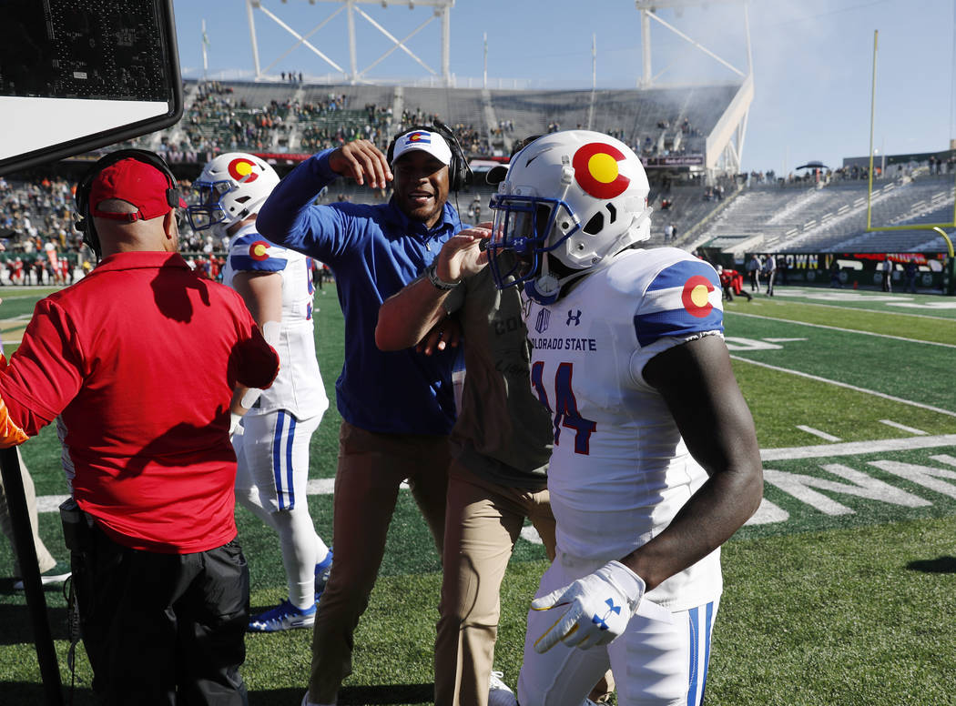 Colorado State kick returner Anthony Hawkins is congratulated after he ran back the opening kic ...