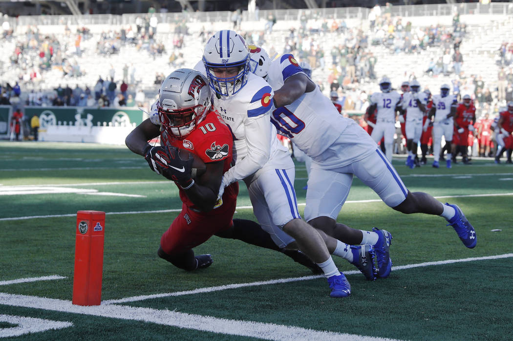 UNLV wide receiver Darren Woods Jr. tumbles into the end zone for a touchdown after catching a ...