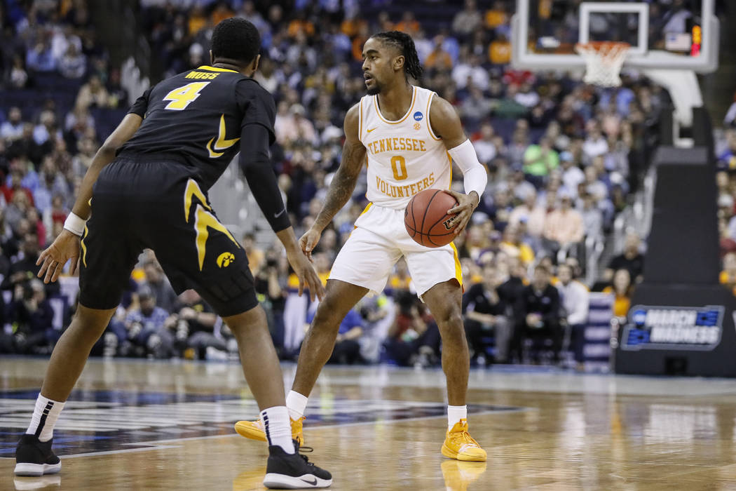 Tennessee's Jordan Bone (0) sets up a play against Iowa's Isaiah Moss (4) in the first half dur ...