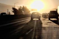 Commuters drive into downtown Los Angeles as the sun rises along Interstate 5 in 2018. (Richard ...