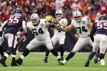 Oakland Raiders quarterback Derek Carr (4) drops back to pass as offensive guard Richie Incogni ...