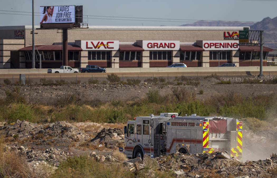 The Henderson Fire Department works a small brush fire just off of the southbound lanes of Inte ...