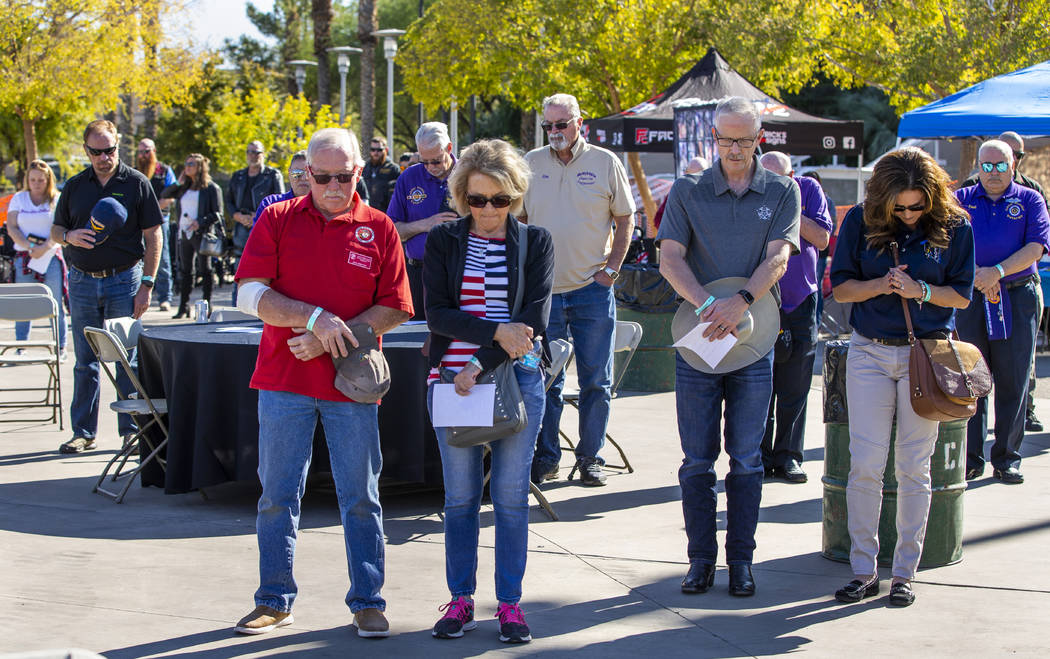 Attendees stand for a prayer following the National Anthem during the 10th Annual One Hero at a ...