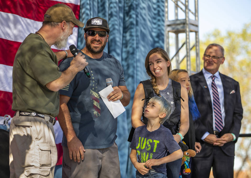 Rich Hillis with One Hero at a Time, left, talks with veteran Daniel Tingle and his family afte ...