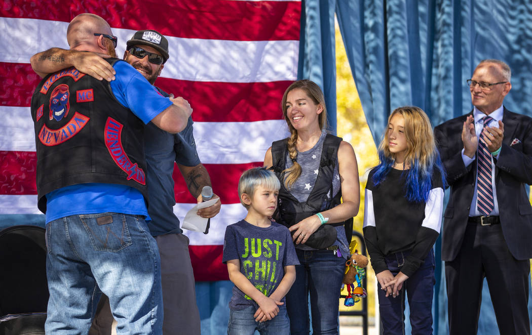 Redd with P.O.B.O.B. Motorcycle Club, left, hugs veteran Daniel Tingle after presenting him wit ...