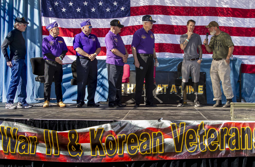 Rich Hillis with One Hero at a Time, right, talks with veteran Adam Poppinhouse and members of ...