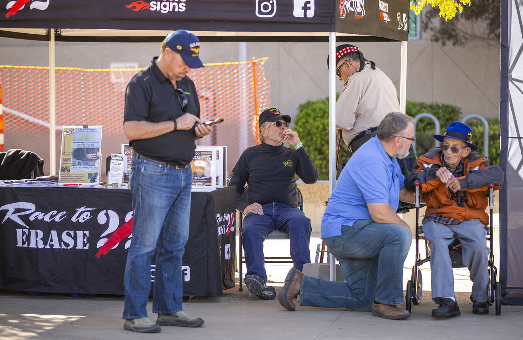 WWII Navy veteran Richard Swenson, right, chats with photographer Mikel Conrad during the 10th ...