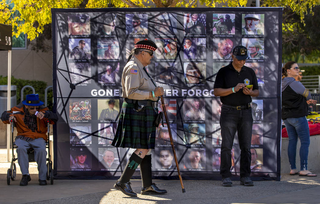 Commander Ed Gilmore with the Scottish-American Military Society Post 711 passes by a memorial ...