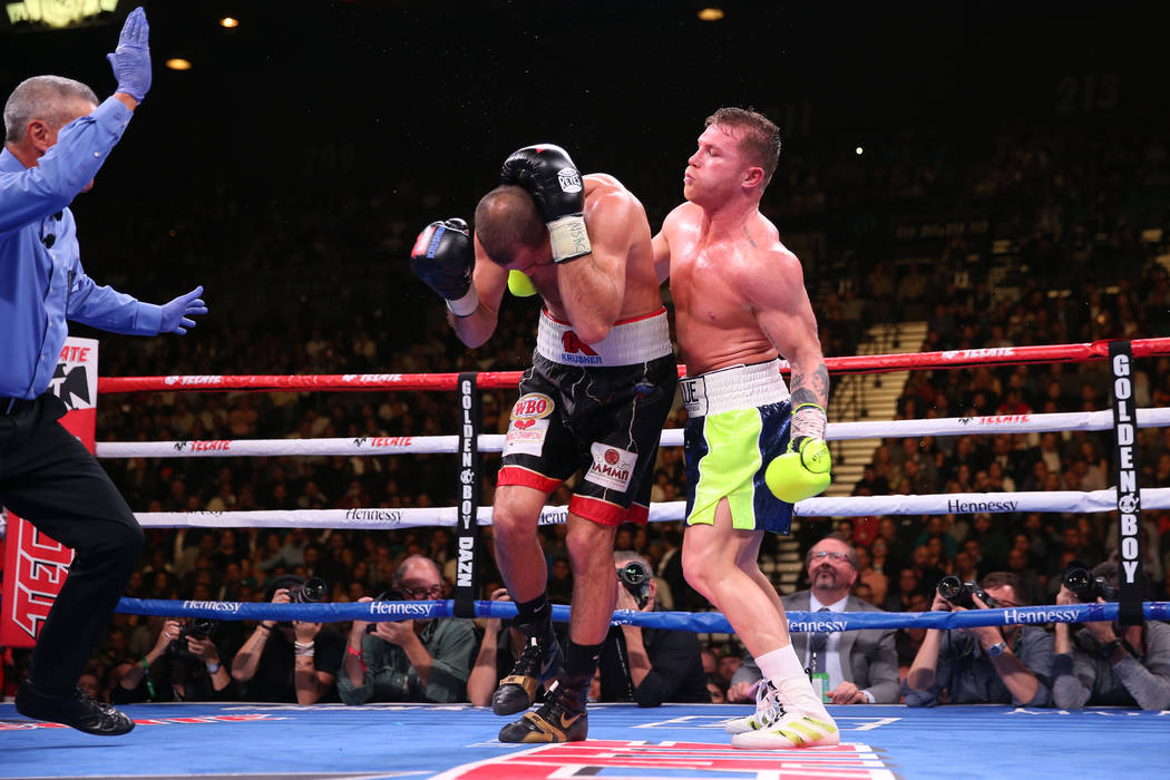 Saul “Canelo” Alvarez, right, gets ready for a punch against Sergey Kovalev durin ...