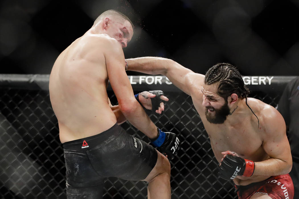Jorge Masvidal, right, punches Nate Diaz during the third round of a welterweight mixed martial ...