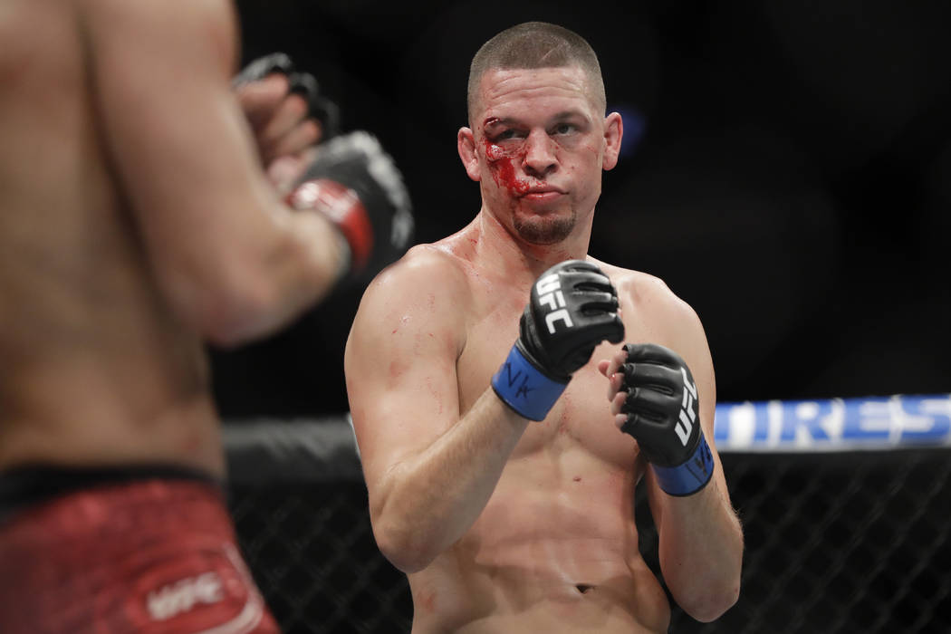 Nate Diaz, right, fights Jorge Masvidal during the first round of a welterweight mixed martial ...