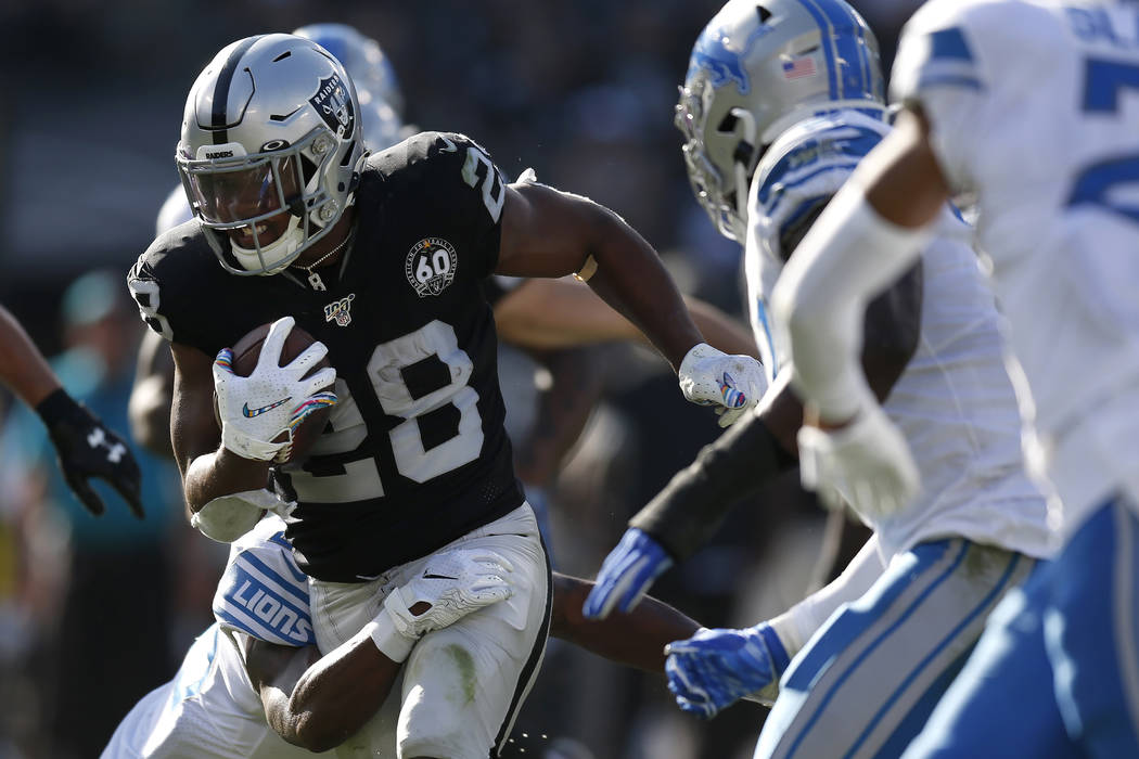 Oakland Raiders running back Josh Jacobs (28) runs against the Detroit Lions during the first h ...