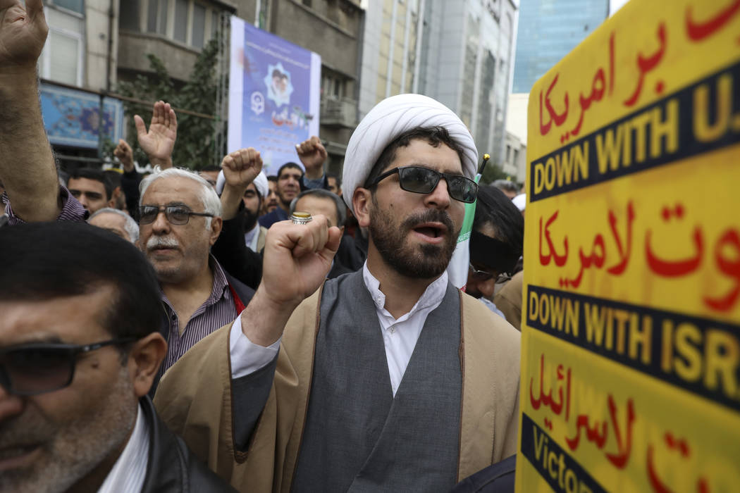 A Shiite Muslim cleric chants slogan during an anti-U.S. annual rally in front of the former U. ...