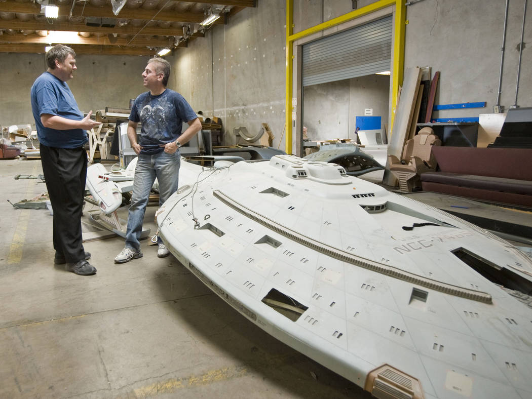 Paul Walker, left, and Alec Peters stand by a model of the Starship Voyager that was used as a ...