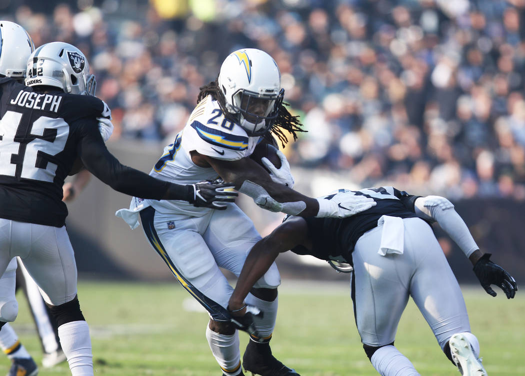 Los Angeles Chargers running back Melvin Gordon (28) runs with the football as Oakland Raiders ...
