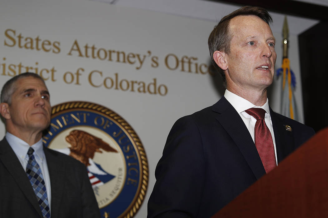 Jason R. Dunn, U.S. Attorney for the District of Colorado, right, makes a point as Dean Phillip ...