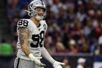Oakland Raiders defensive end Maxx Crosby (98) gestures after being penalized for roughing the ...
