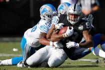 Oakland Raiders tight end Darren Waller (83) is tackled by Detroit Lions defensive back Will Ha ...