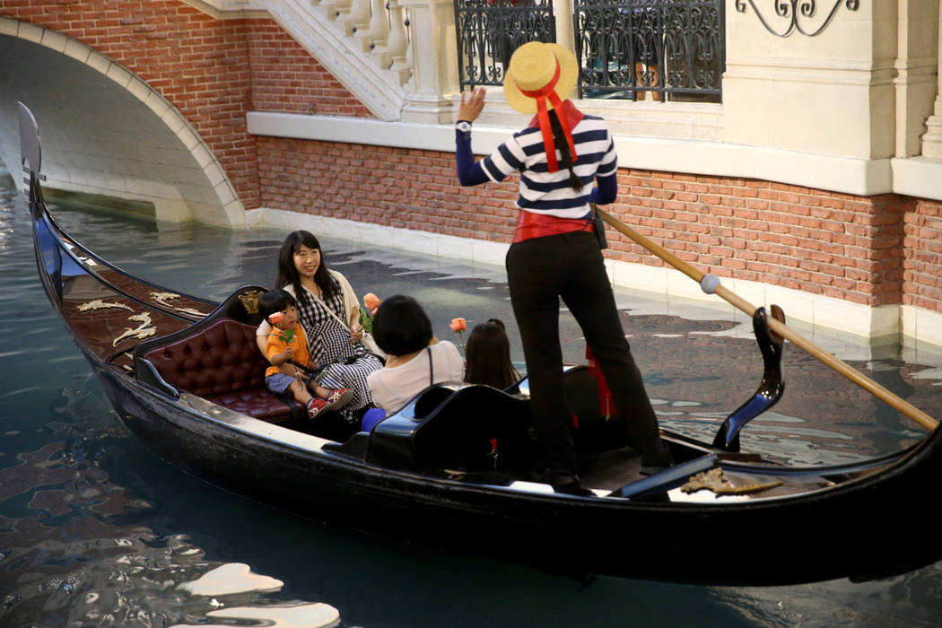 Kanako Arai of Japan, top left, and Reiko Yuasa, ride in a gondola with Arai's children Shotaro ...