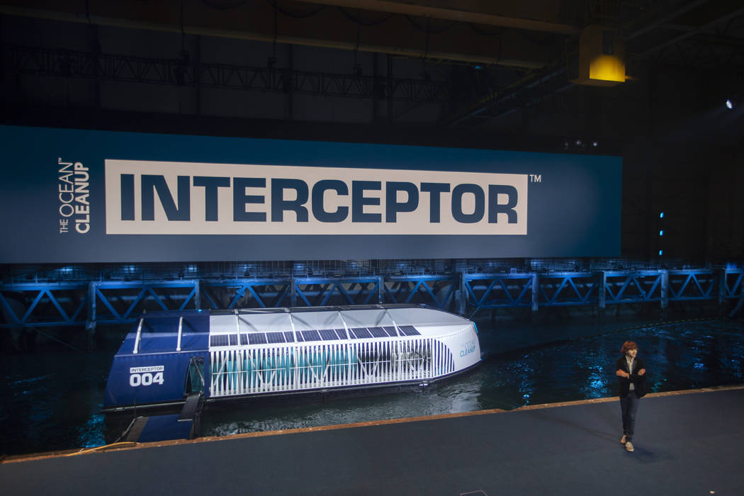 Young Dutch inventor Boyan Slat, right, unveils the Interceptor in Rotterdam, Netherlands, Satu ...