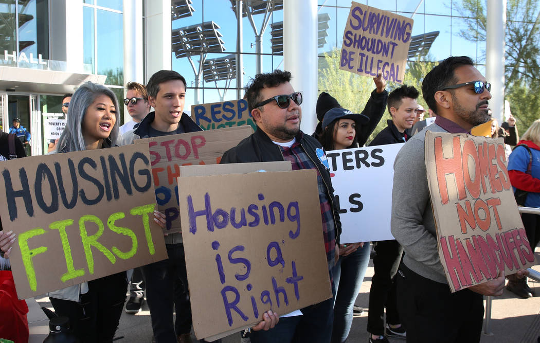 Protesters shout slogans as they hold signs outside Las Vegas City Hall during a protest agains ...