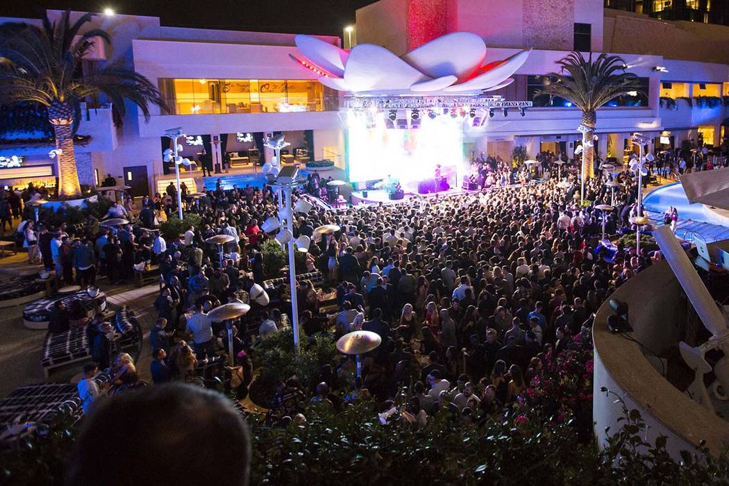 Attendees dance to Saint Jhn around the outdoor area the during the grand opening weekend of Ka ...