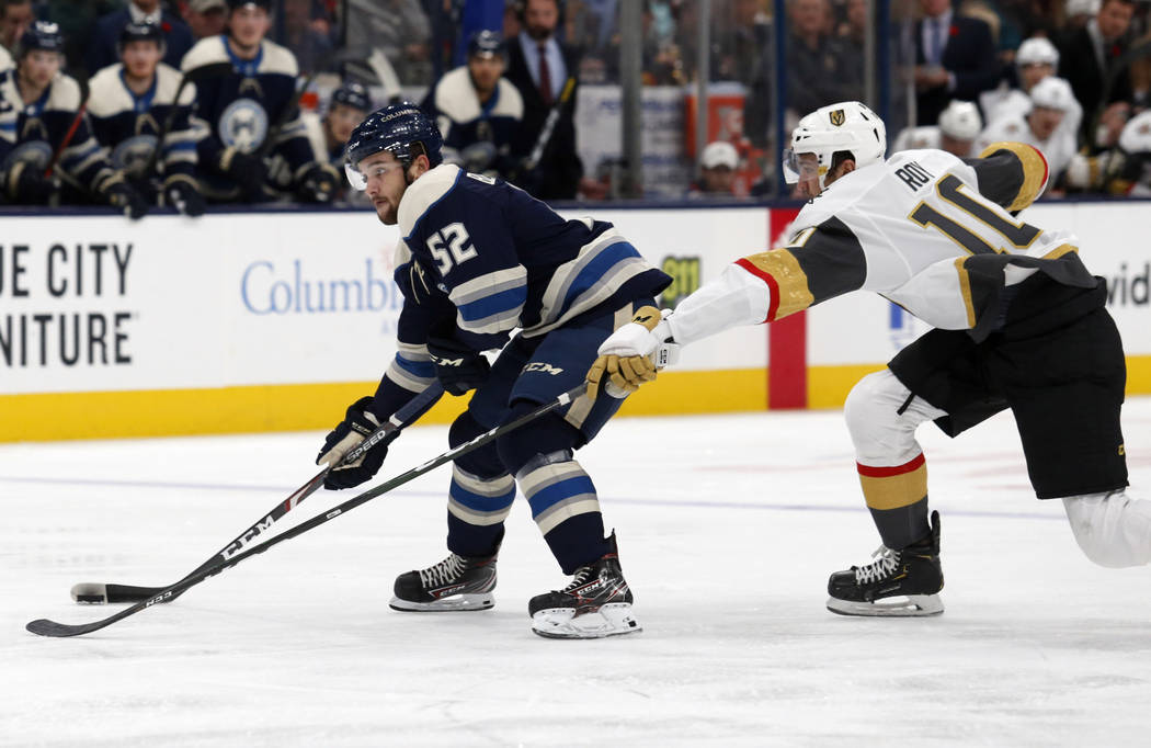 Columbus Blue Jackets forward Emil Bemstrom, left, of Sweden, controls the puck in front of Veg ...