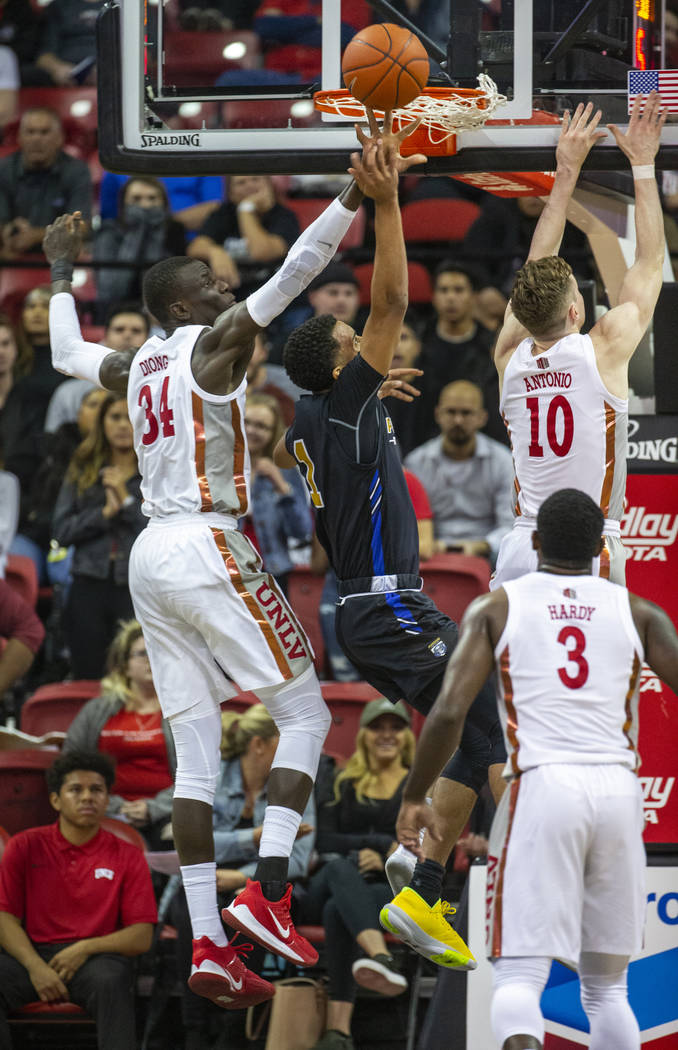 UNLV Rebels forward Cheikh Mbacke Diong (34, left) rejects a shot by Purdue Fort Wayne guard Ja ...