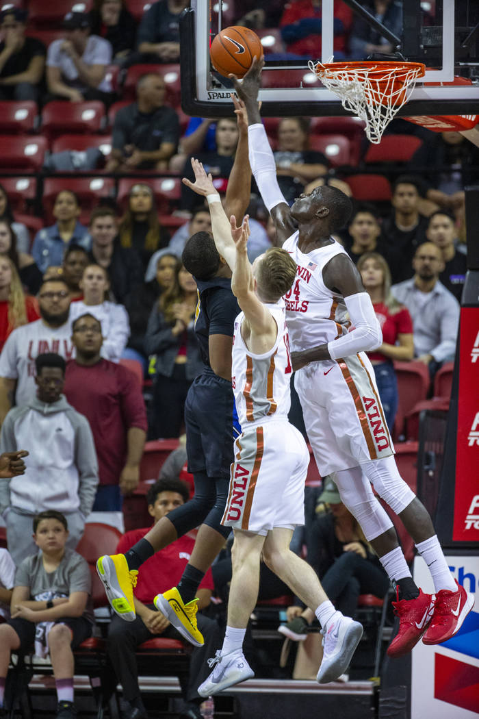 UNLV Rebels forward Cheikh Mbacke Diong (34, right) rejects a shot by Purdue Fort Wayne guard J ...