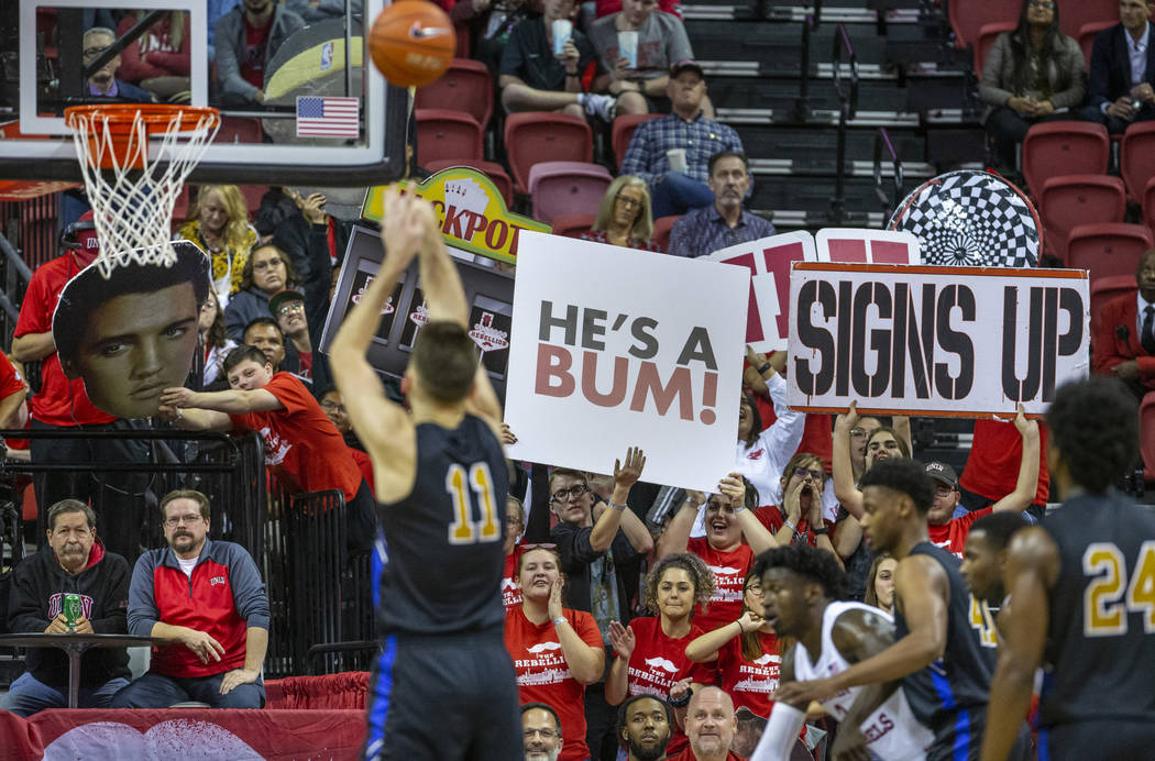 UNLV Rebels fans do their best to distract Purdue Fort Wayne forward Dylan Carl (11) while shoo ...