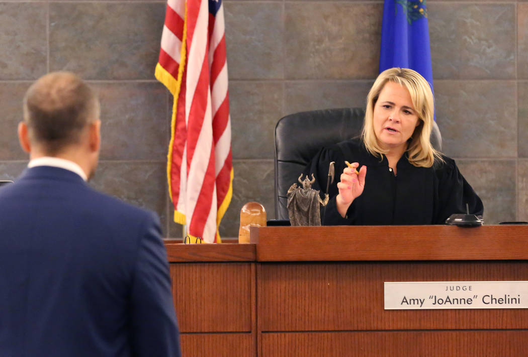Attorney Ross Goodman, left, listens as Las Vegas Justice of the Peace Amy Chelini speaks durin ...